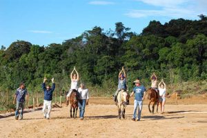 A group of volunteers riding horses.